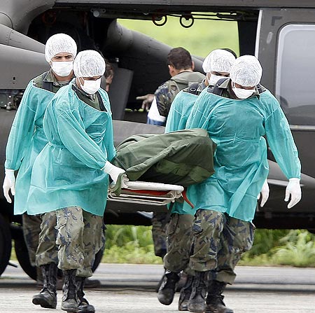 a body recovered from flight 447 is carried from a helicopter